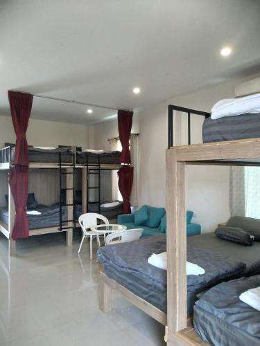 a room with three bunk beds and a couch at ขุนโลหะ K̄hun loh̄a in Phuket