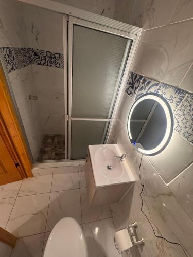 a bathroom with a toilet and a sink and a mirror at Lodge Ayla Punta Mango in Jucuarán