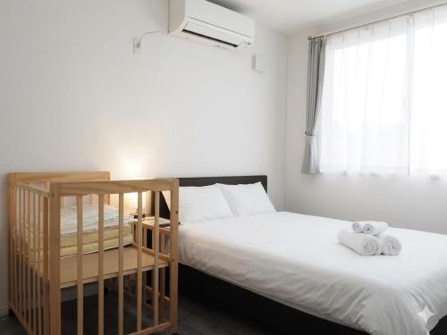 a bedroom with a bed with two towels on it at The MOON in Sapporo