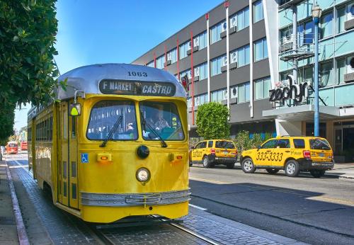 a yellow trolley car on a city street at Hotel Zephyr San Francisco in San Francisco