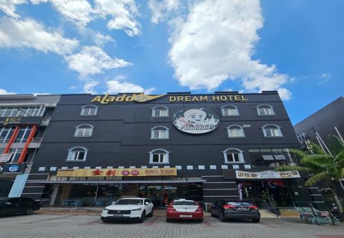 a hotel with cars parked in front of it at Aladdin Dream Hotel in Johor Bahru
