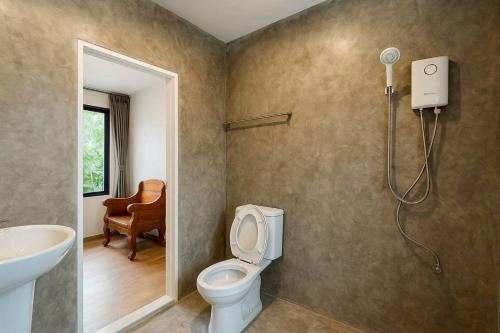 a bathroom with a toilet and a sink at innbox Chiangmai Hotel in Ban Si Ngam