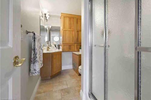a bathroom with a shower and a sink at Cozy cottage on the River in Port Dover
