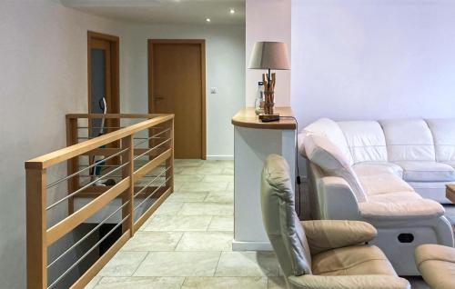 a salon with a chair and a stair case at 3 Bedroom Amazing Home In Mutigney in Mutigney