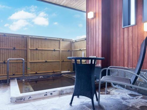 a patio with a table and chairs and a pool at Manten no Yado in Gujo
