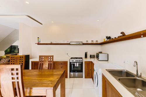 a kitchen with a sink and a stove at Du Ciel Villa by Betterplace in Canggu