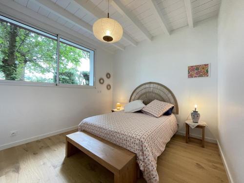 a bedroom with a bed and a large window at Hartzurienea in Anhaux