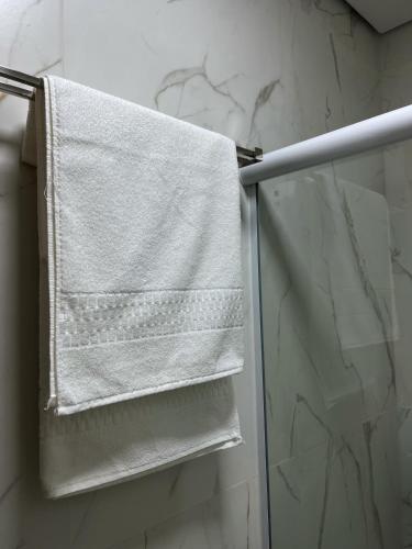 a towel hanging on a towel rack in a bathroom at Hotel Blox Sorriso in Sorriso