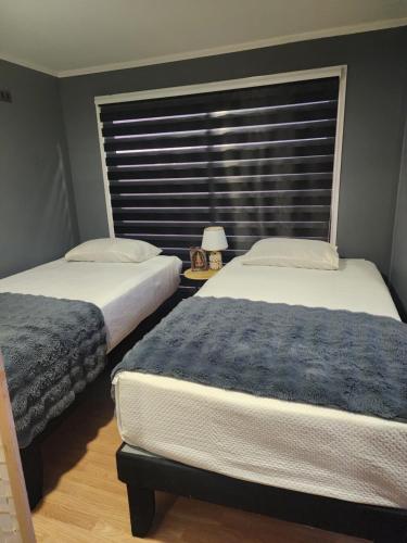 two beds sitting in a room with a window at Tiny por trabajo in Trinidad