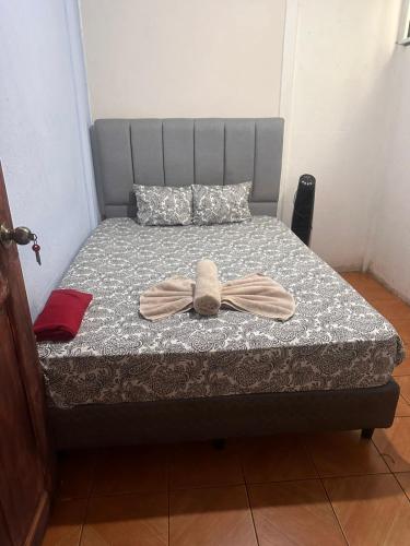 a bed with a bow on top of it at GuestHouse Detours CR in Fortuna