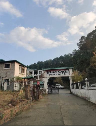 a ring oak garage with a sign on it at Pine Galaxy in Bhowāli