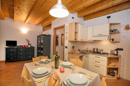 a kitchen and dining room with a table and chairs at Appartamento Centro Storico Riva - Happy Rentals in Riva del Garda