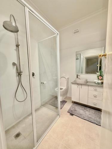 a bathroom with a shower and a toilet and a sink at 72 Cobra Street House in Dubbo