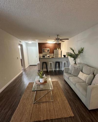 a living room with a couch and a table at Modern 2BR Hollywood Apt with Rooftop Pool, Free Parking & Close to Walk of Fame and Universal Studios in Los Angeles