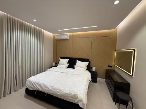 a bedroom with a large bed and a television at رولارا بلازا in Medina