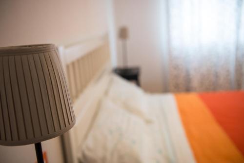 a bedroom with a bed with a lamp next to it at B&B da Viky in Marostica