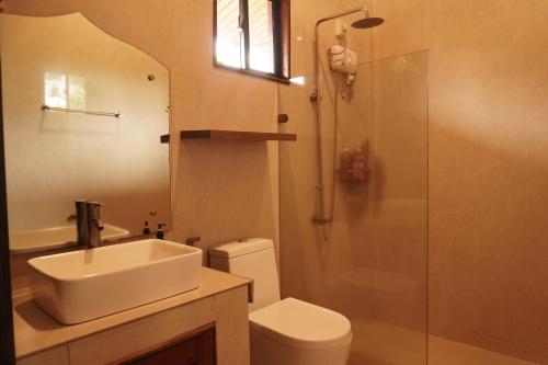 a bathroom with a sink and a shower and a toilet at Casa Salome in Matas