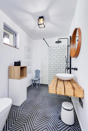 a bathroom with a tub and a sink and a table at Káli Kert Vendégház in Szentbékkálla