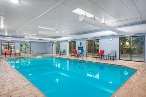 a large swimming pool with blue water in a building at La Quinta by Wyndham Clarksville in Clarksville