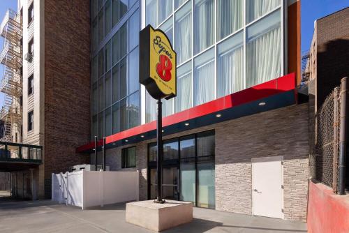 a building with a sign in front of it at Super 8 by Wyndham Bronx Near Stadium in Bronx