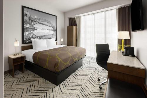 a hotel room with a bed and a large window at Super 8 by Wyndham Bronx Near Stadium in Bronx