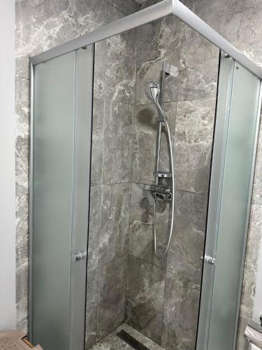 a shower with a glass door in a bathroom at ЖК Парус, 10-1 in Chornomorsk
