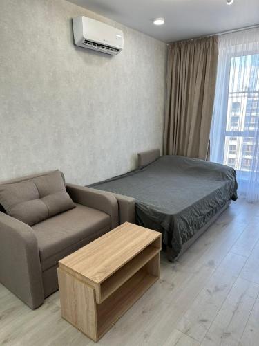 a living room with a bed and a couch at ЖК Парус, 10-1 in Chornomorsk
