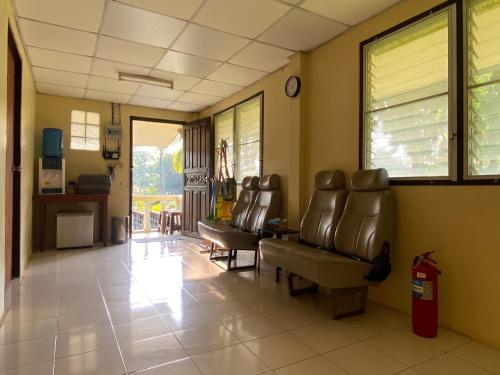 a waiting room with leather chairs and a waiting room at Roy Lao House in Khao Lak