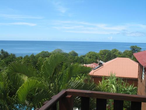 a view of the ocean from the balcony of a house at Gîtes BB in Bouillante
