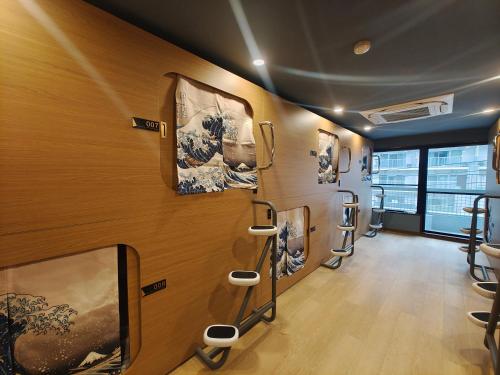 a room with a row of framed pictures on the wall at Louis House Shibuya in Tokyo
