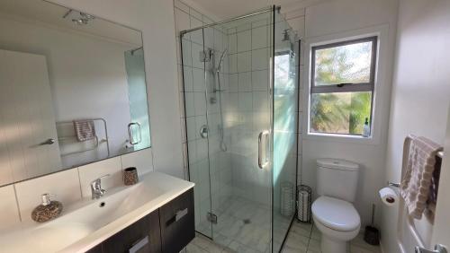 a bathroom with a shower and a toilet and a sink at Huntington Hideaway in Hamilton