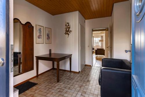 a living room with a table and a couch at Ferienhuus Wietkieker in Nordstrand