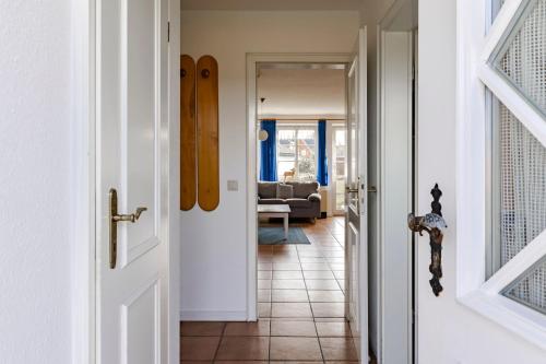 a hallway with a door leading to a living room at Friesenhof am Deich in Nordstrand