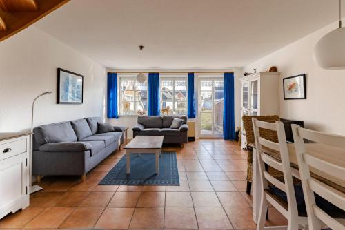 a living room with a couch and a table at Friesenhof am Deich in Nordstrand