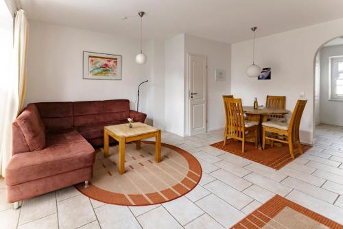 a living room with a couch and a table at Haus am Kurhaus 9 in Nordstrand