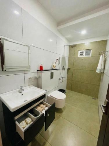 a bathroom with a sink and a toilet and a shower at JK Residency in Kunnamangalam
