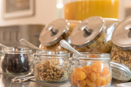 a group of jars filled with different types of food at Heartland Hotel Glacier Country in Fox Glacier