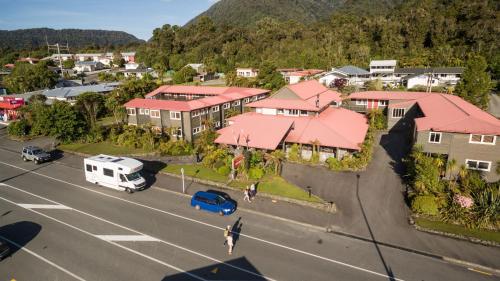 an aerial view of a town with houses and a street at Heartland Hotel Glacier Country in Fox Glacier
