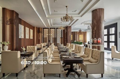a dining room with a long table and chairs at NIA Hotel in Da Lat