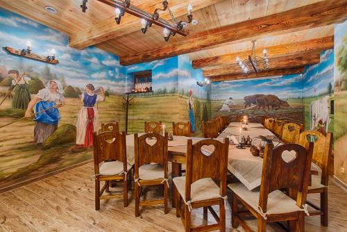 a dining room with a painting on the wall at Hotel Dwór Fijewo in Golub-Dobrzyń
