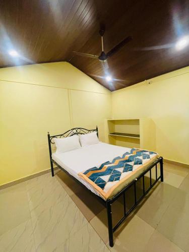 a bed in a room with a ceiling at Gokarna Beach Vibes in Gokarn