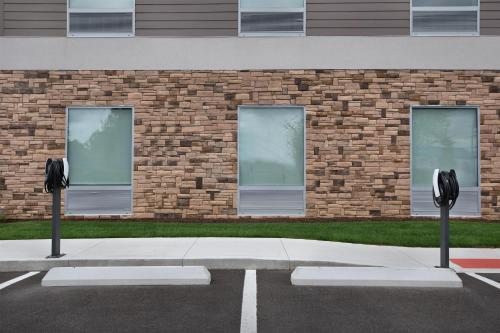 two parking meters in front of a brick building at Home2 Suites By Hilton Columbus Easton in Columbus