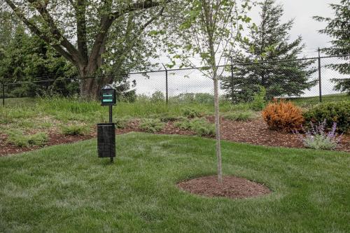 a green meter next to a tree in a yard at Home2 Suites By Hilton Columbus Easton in Columbus