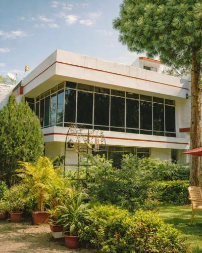 a building with a bunch of plants in front of it at Pine Tree Resort Betla in Kechki