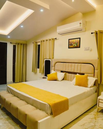 a bedroom with a large bed with yellow pillows at Pine Tree Resort Betla in Kechki