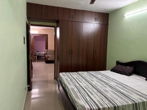 a bedroom with a bed and a wooden cabinet at Satya Residency in Kākināda