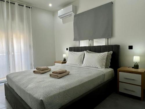 a bedroom with a bed with two towels on it at Kilada Luxury Apartment 2 in Koilás