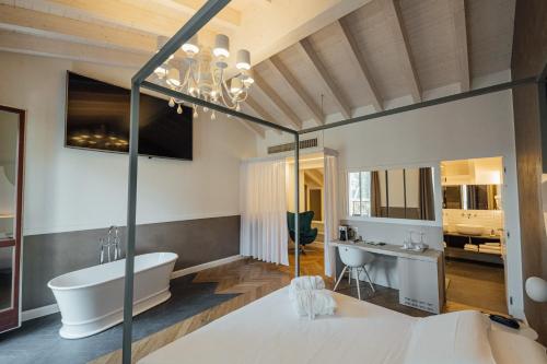 a bathroom with a tub and a sink at Hotel Bigio in San Pellegrino Terme