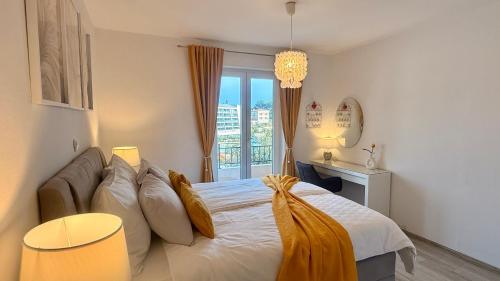 a bedroom with a bed with pillows and a window at Apartment Lučka II in Banjol