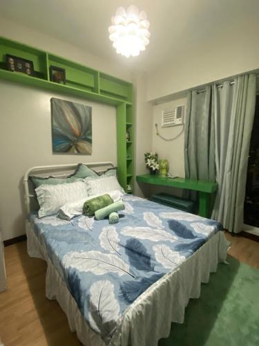 a bedroom with a bed with a teddy bear on it at Verdon Parc Butterfly Haven in Davao City